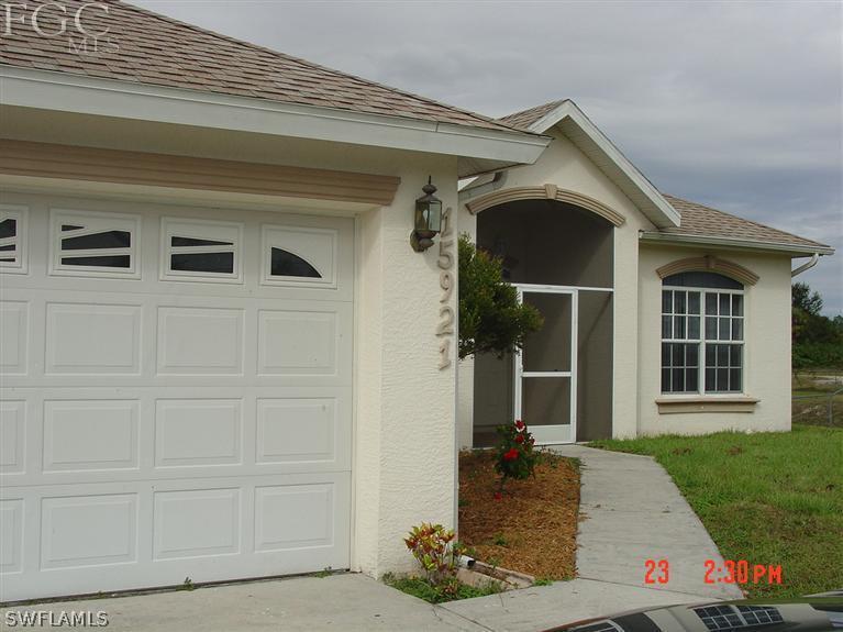 15921 Cemetery Road Fort Myers, FL 33905 - Photo 3 of 25 front view of a house with a yard