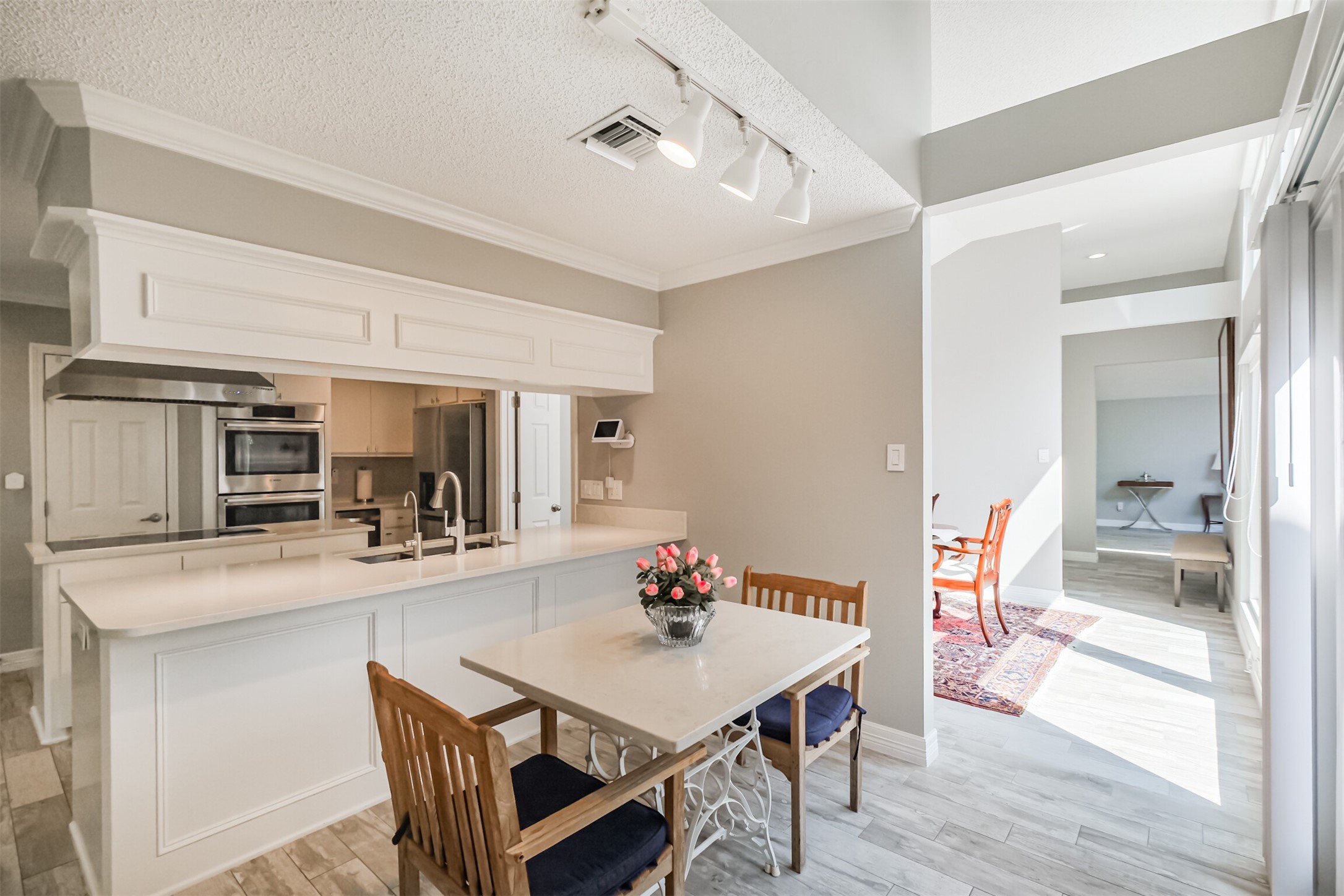 1007 Arrow Hill Road Houston, TX 77077 - Photo 11 of 48 When walking from the dining room into the kitchen there is cozy space by the kitchen big enough for a small breakfast table. You can also utilize the eat-in breakfast bar and add seating there.