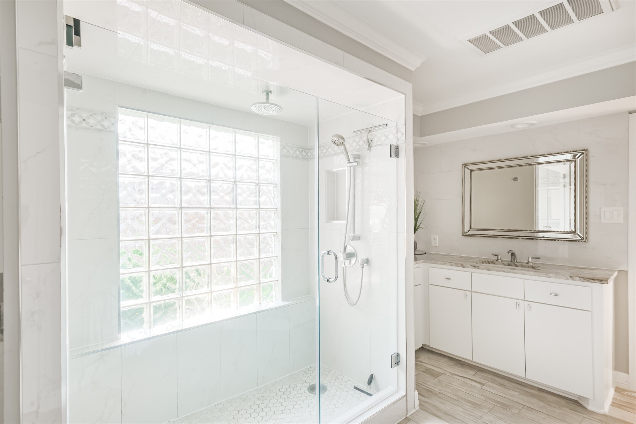 1007 Arrow Hill Road Houston, TX 77077 - Photo 26 of 48 There is an updated standing shower with tile surround and a seamless glass door in the primary bathroom.