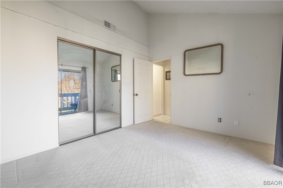 760 Blue Jay Road, Unit 34 Big Bear Lake, CA 92315 - Photo 14 of 24 an empty room with mirror and doors