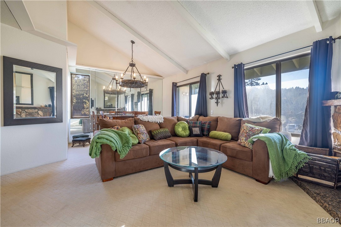760 Blue Jay Road, Unit 34 Big Bear Lake, CA 92315 - Photo 5 of 24 a living room with furniture and a chandelier