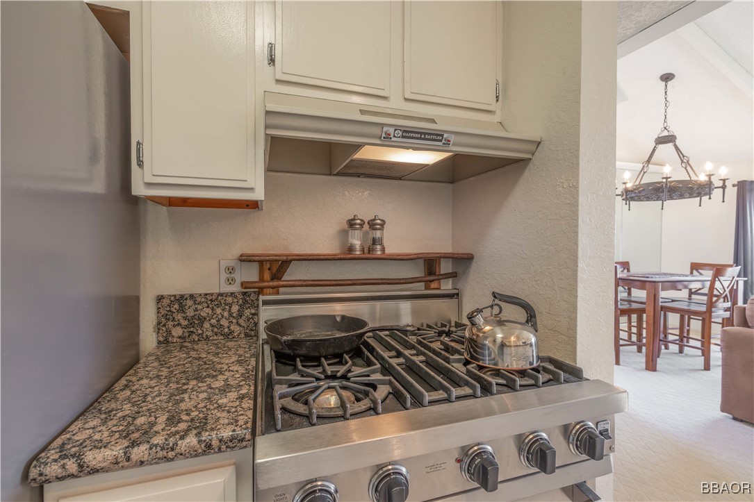 760 Blue Jay Road, Unit 34 Big Bear Lake, CA 92315 - Photo 9 of 24 a kitchen with a stove and cabinets
