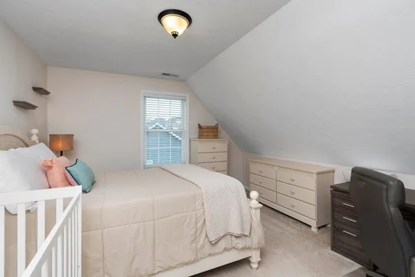 a bedroom with a bed and cabinets
