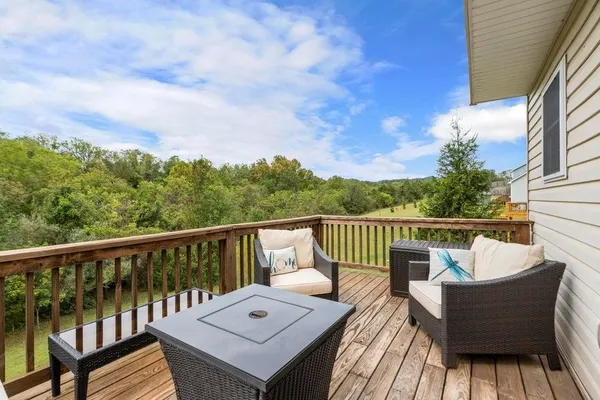 a view of a wooden chairs on the deck