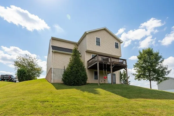 a view of house with backyard and garden