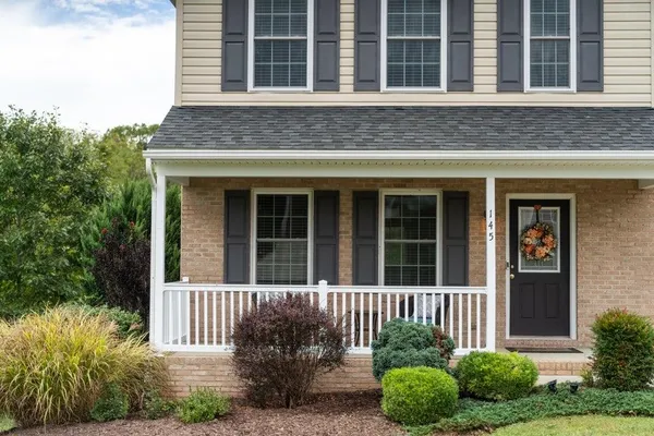 a front view of a house with a yard