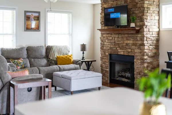 a living room with furniture and a fireplace