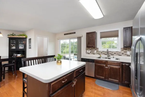 a kitchen with a stove a sink and a refrigerator