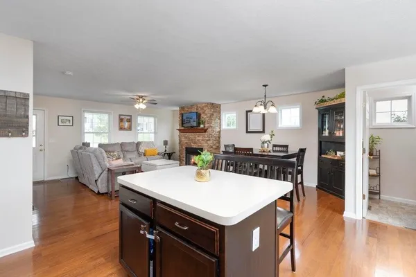 a kitchen with a table chairs and wooden floor