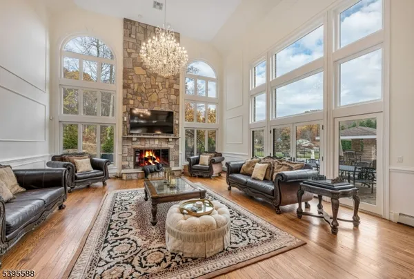 a living room with fireplace furniture and a rug