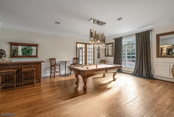a living room with furniture a dining table and a wooden floor