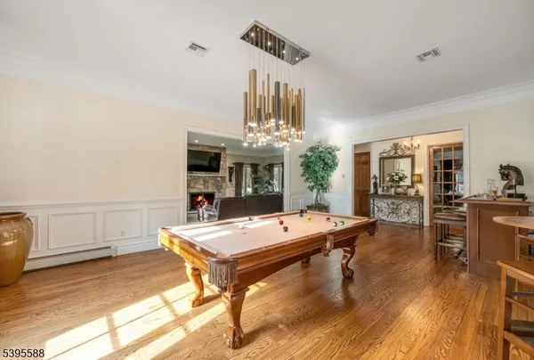 a room with pool table and window