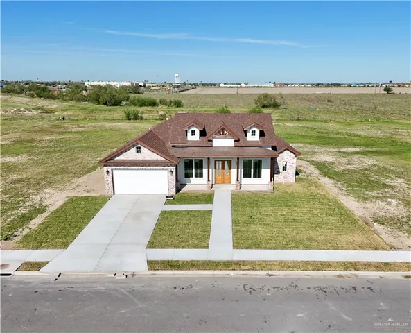 a view of a lake with a big yard and large trees