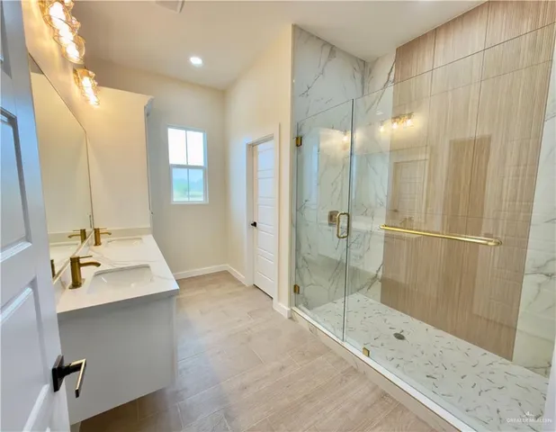 a bathroom with a shower sink and mirror