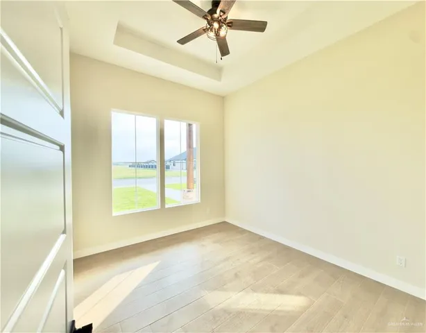 a view of a room with a window and a ceiling fan