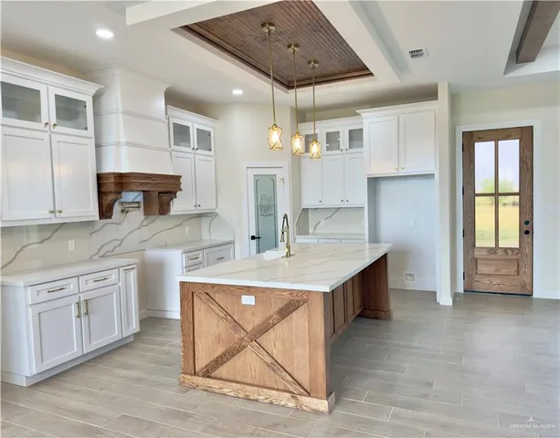 a kitchen with a sink cabinets and window