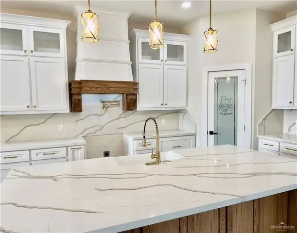 a kitchen with a sink and a refrigerator