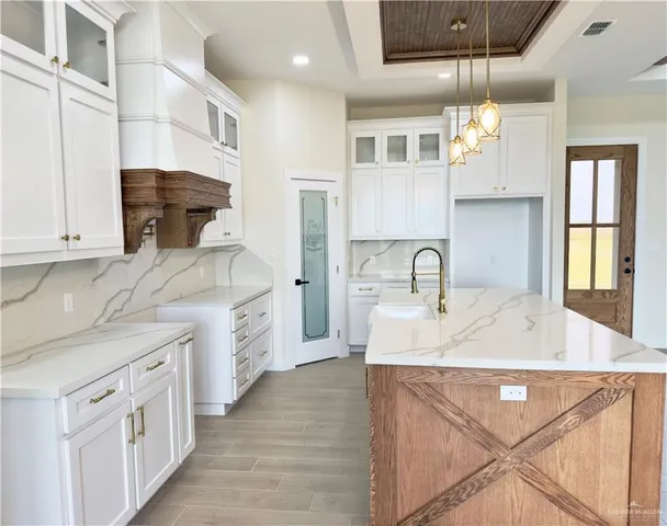 a large kitchen with kitchen island a sink stainless steel appliances and cabinets