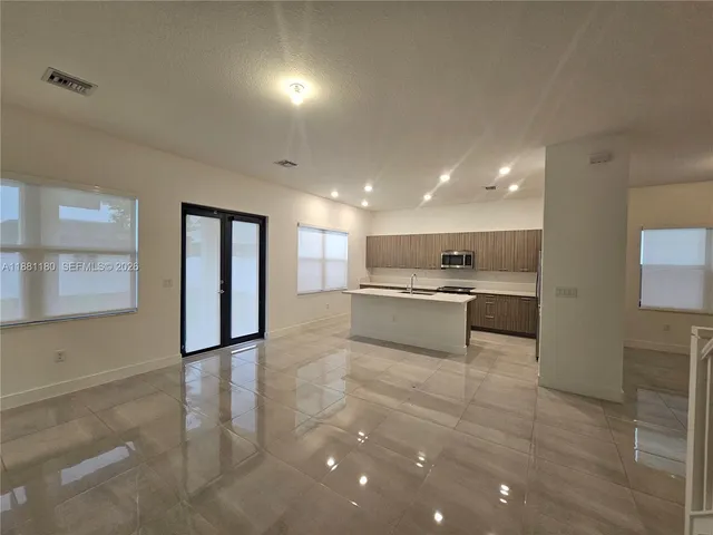 a kitchen with a sink a refrigerator and a stove