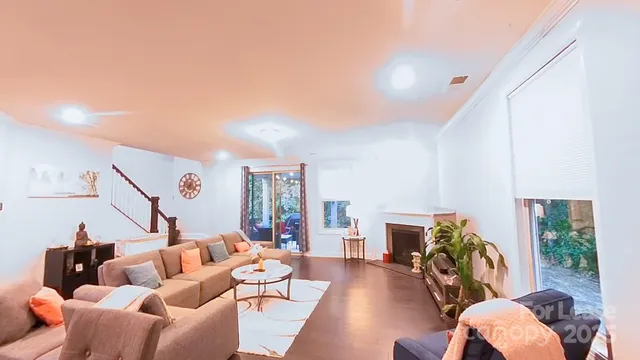 a living room with furniture a fireplace and a potted plant