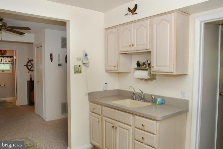 1414 Oak Bluff Road Edgewater, MD 21037 - Photo 1 of 21 a kitchen with stainless steel appliances granite countertop white cabinets and sink