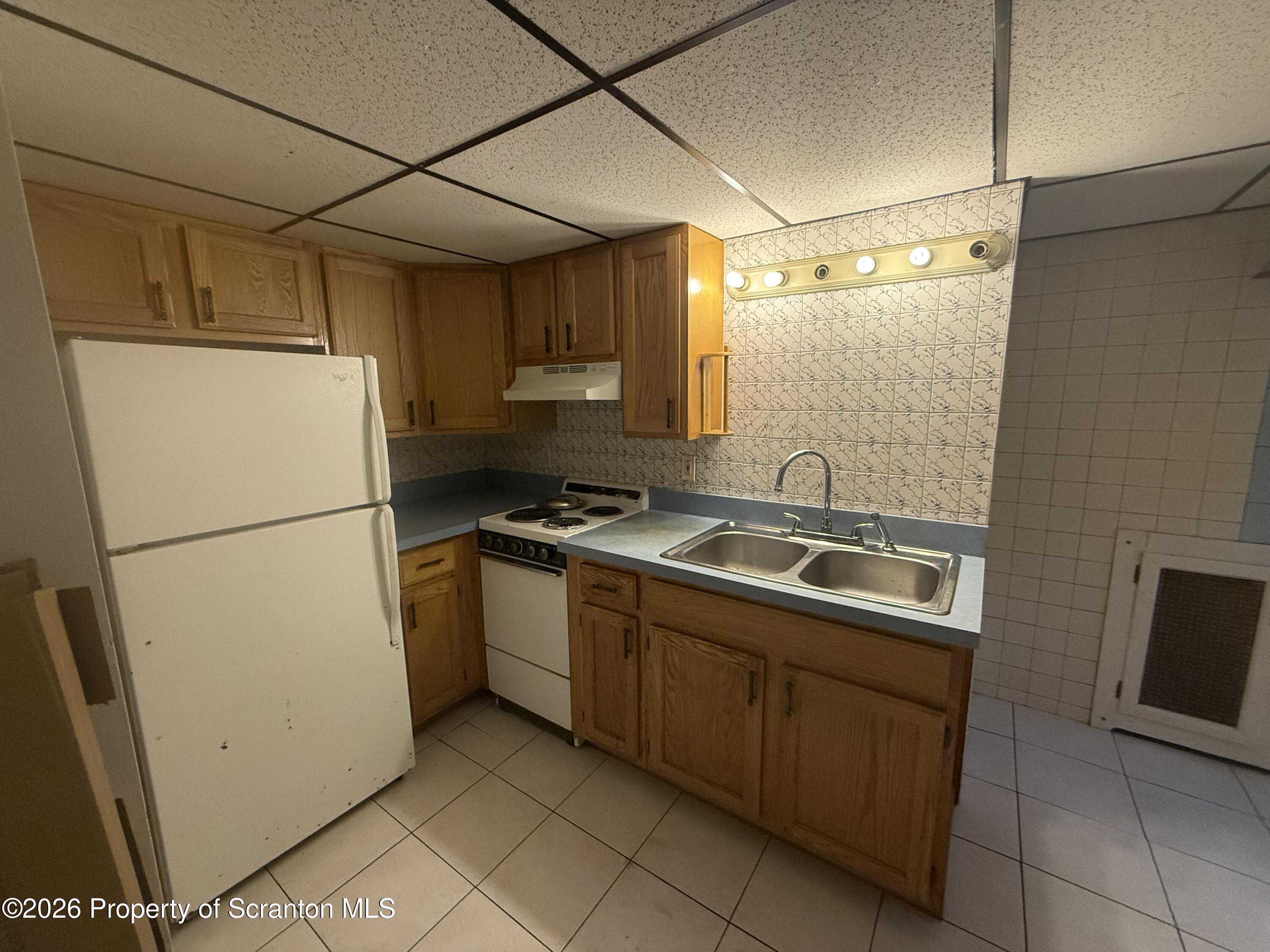 1301 Main Street, Unit 7 Dickson City, PA 18519 - Photo 2 of 7 a kitchen with stainless steel appliances granite countertop a refrigerator and a sink