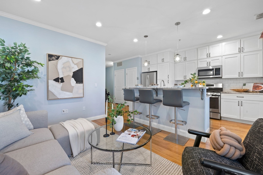 a living room with furniture and kitchen view