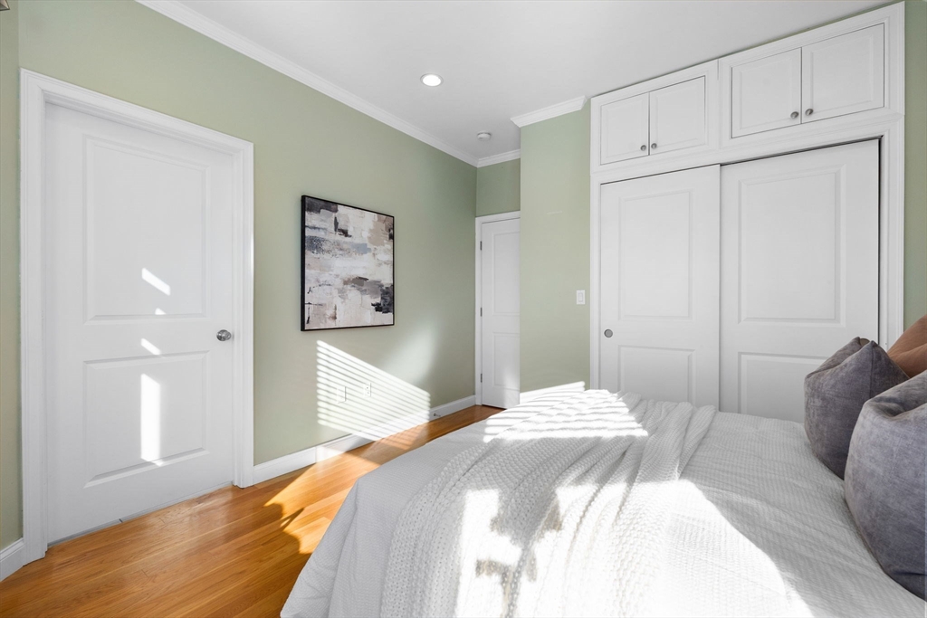 242 West Fifth Street, Unit 3 Boston, MA 02127 - Photo 18 of 37 a bedroom with a bed and a painting