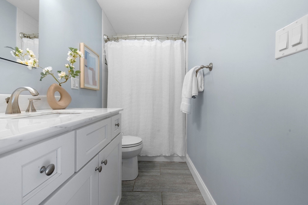242 West Fifth Street, Unit 3 Boston, MA 02127 - Photo 25 of 37 a bathroom with a granite countertop sink toilet and shower