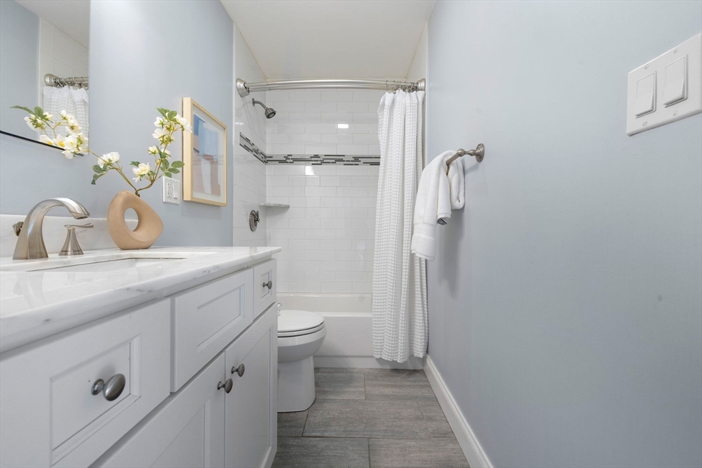 242 West Fifth Street, Unit 3 Boston, MA 02127 - Photo 26 of 37 a bathroom with a granite countertop sink toilet and shower