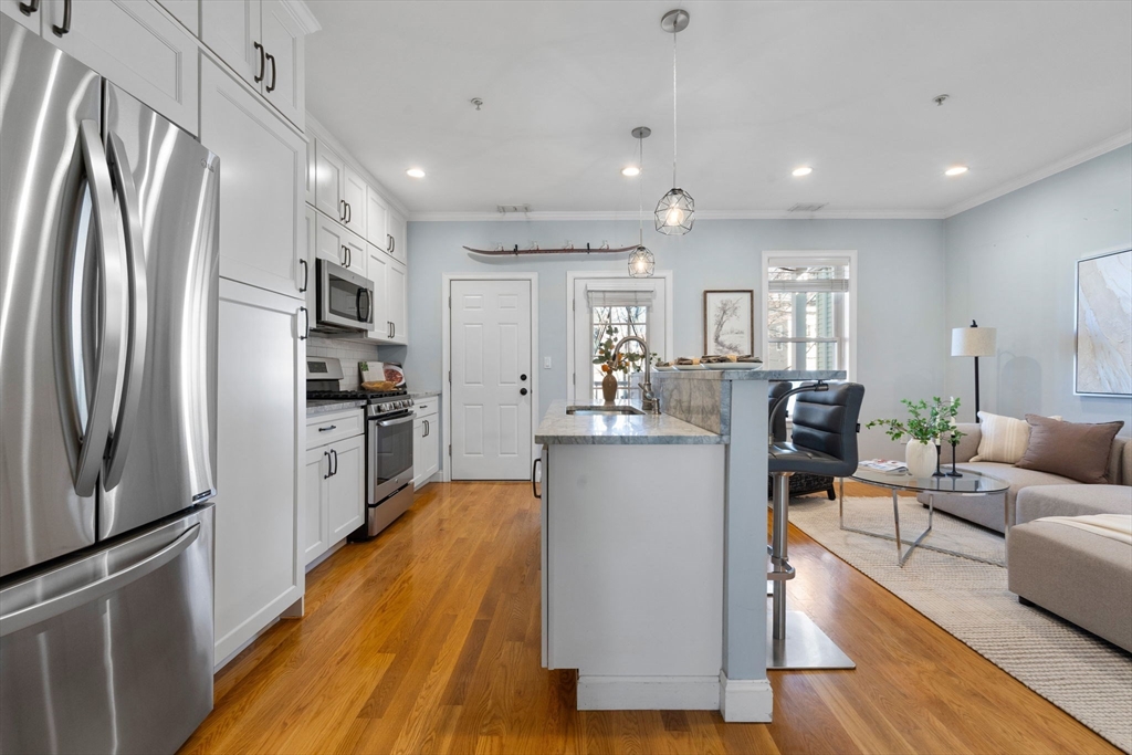 242 West Fifth Street, Unit 3 Boston, MA 02127 - Photo 8 of 37 a living room with furniture and a kitchen view