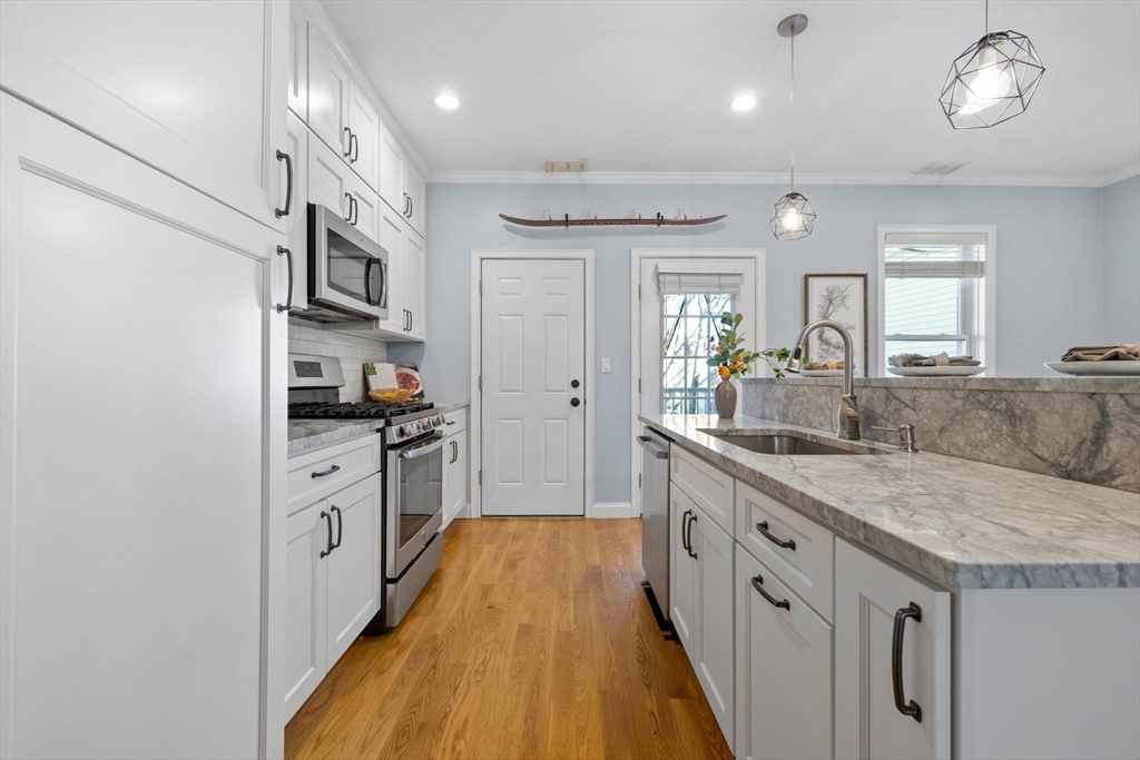 242 West Fifth Street, Unit 3 Boston, MA 02127 - Photo 9 of 37 a large kitchen with stainless steel appliances granite countertop a lot of counter space and wooden floor