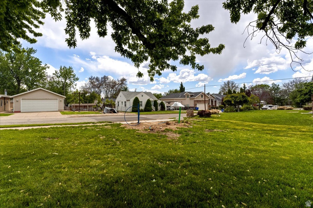 385 East Randall Way South, Unit 2 Centerville, UT 84014 - Photo 10 of 21 View of green lawn featuring a detached garage