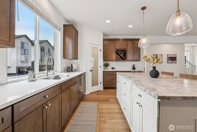 a kitchen with stainless steel appliances granite countertop a sink and cabinets