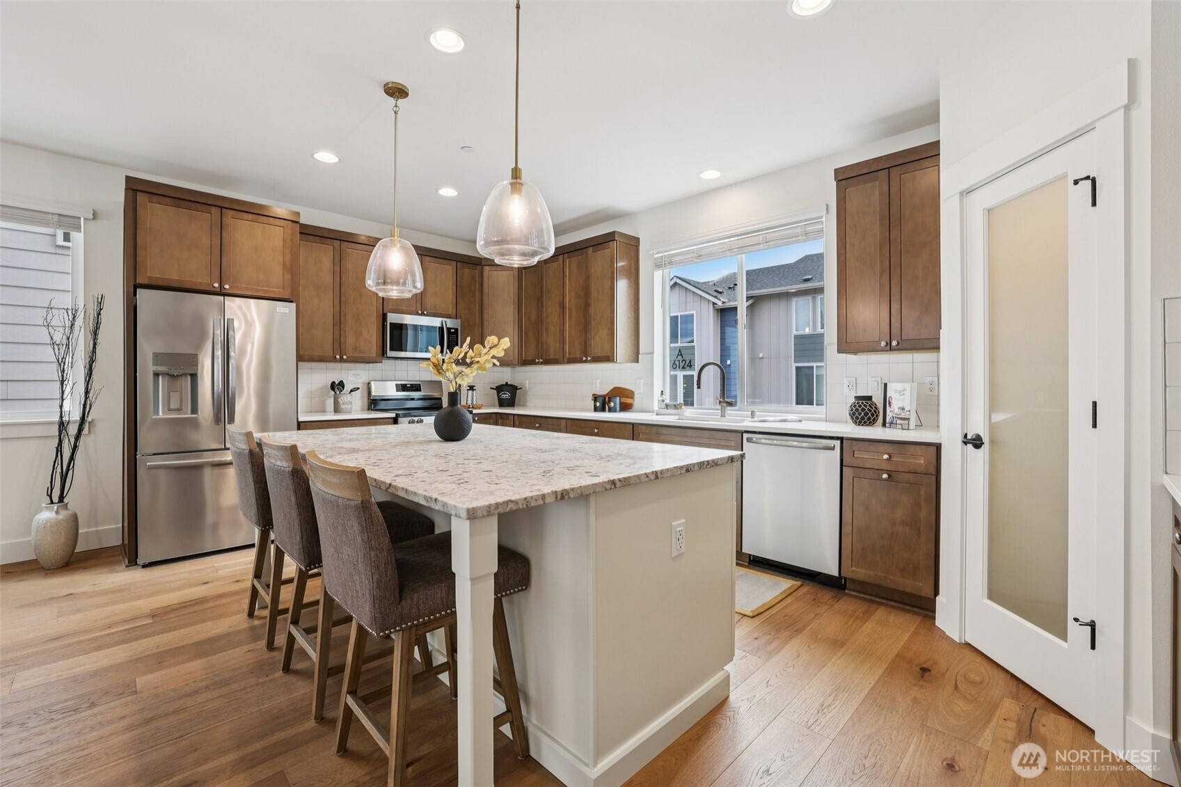 14 160th Place Southeast Bothell, WA 98012 - Photo 15 of 39 a kitchen with stainless steel appliances kitchen island granite countertop a refrigerator a sink dishwasher a stove and white cabinets with wooden floor