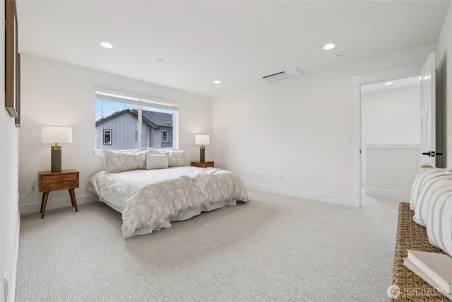 a spacious bedroom with a bed and a couch