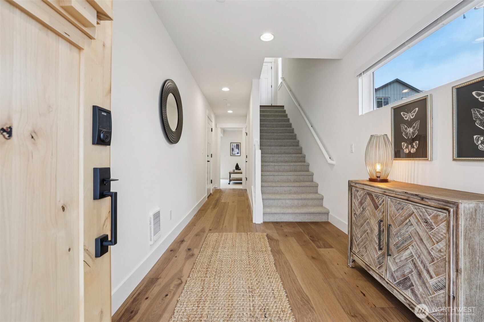 14 160th Place Southeast Bothell, WA 98012 - Photo 2 of 39 a view of a hallway with wooden floor and staircase