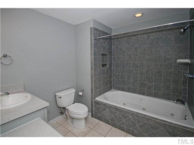 8304 Heel Stone Court Raleigh, NC 27613 - Photo 14 of 25 The remolded Master bath has tile floors and shower, a Jacuzzi tub, and extended vanity. Master Bath/Spa