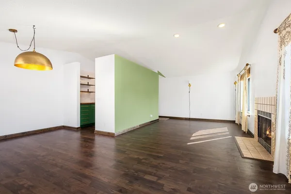 a view of a room with wooden floor and window