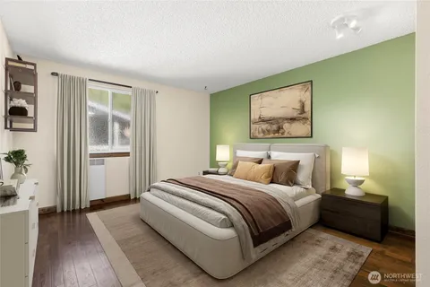 a bedroom with a bed and a painting on the wall