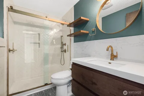 a bedroom with a bed a couch and a potted plant