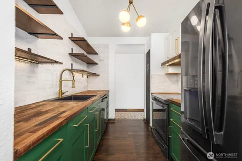 a kitchen with stainless steel appliances granite countertop a stove and a refrigerator