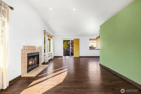 a view of livingroom with fireplace wooden floor and window