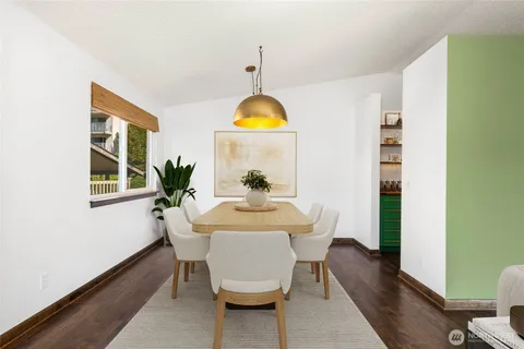 a view of a room with wooden floor and window