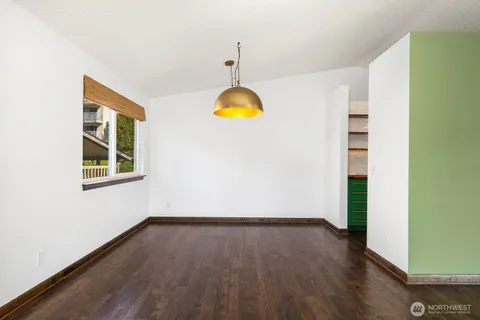 a view of a room with wooden floor and window