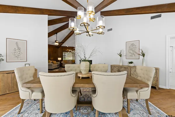 a view of a dining room with furniture and wooden floor