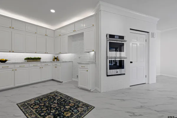 a kitchen with stainless steel appliances a refrigerator and cabinets