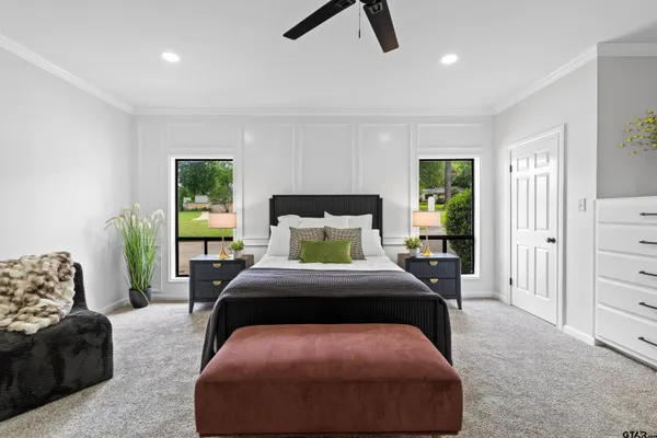 a bedroom with a bed a couch and a window