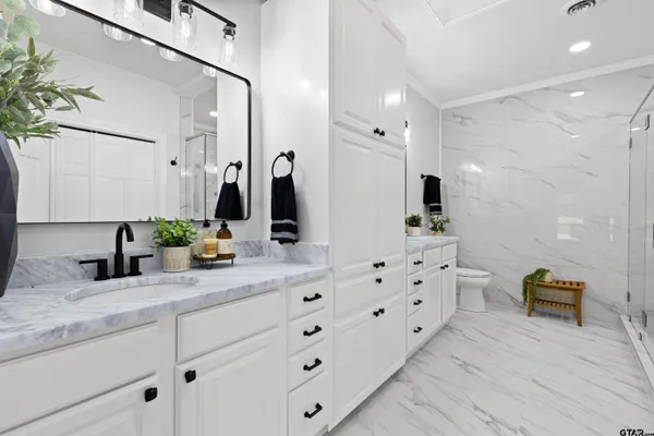 a bathroom with double vanity sink and a mirror