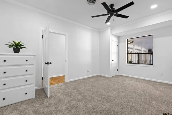 a view of a livingroom with a ceiling fan and window